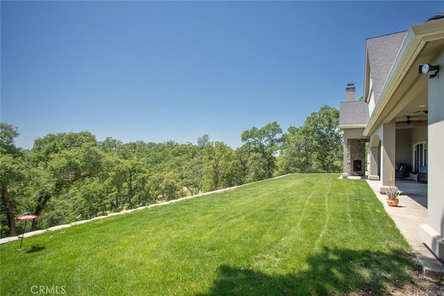 2483 Manhattan Bar Rd, Auburn, CA 95603 - view of green lawn featuring a ceiling fan and a patio area