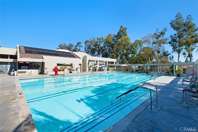 community pool with a patio area