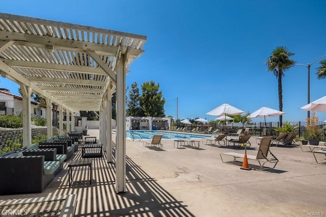 pool with a pergola, a patio area, and fence