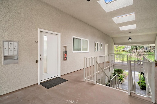 663 Via Los Altos Unit Q, Laguna Woods, CA 92637 - doorway to property featuring stucco siding and a porch