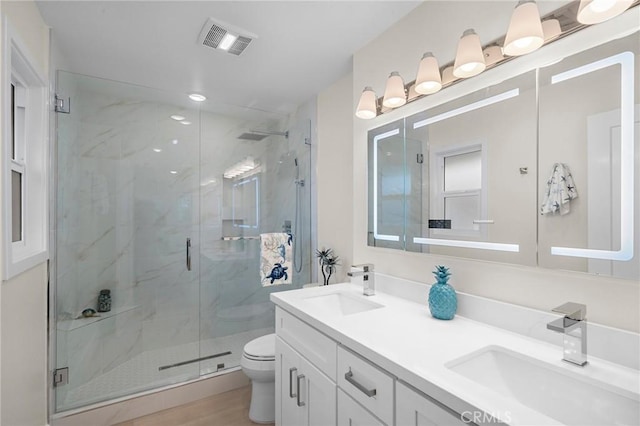 663 Via Los Altos Unit Q, Laguna Woods, CA 92637 - bathroom with double vanity, a marble finish shower, and toilet