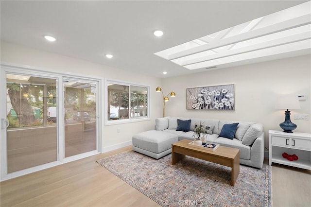 663 Via Los Altos Unit Q, Laguna Woods, CA 92637 - living room featuring light wood-style floors, recessed lighting, a skylight, and baseboards