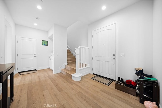 63 Birmingham, Irvine, CA 92620 - foyer entrance with stairway, light wood finished floors, recessed lighting, and baseboards