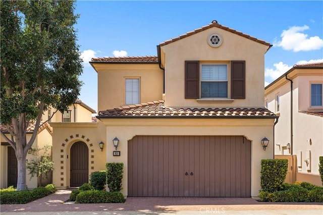 63 Birmingham, Irvine, CA 92620 - mediterranean / spanish house featuring decorative driveway, stucco siding, and a tile roof