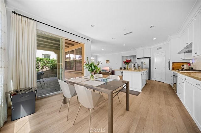 63 Birmingham, Irvine, CA 92620 - dining area featuring light wood-style floors, ornamental molding, and recessed lighting