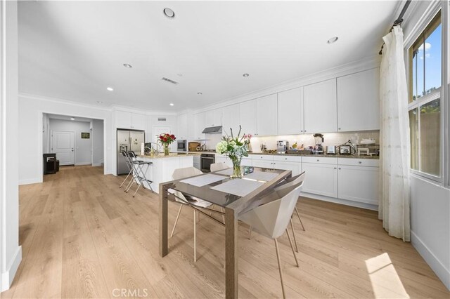 63 Birmingham, Irvine, CA 92620 - dining area with light wood-style floors, ornamental molding, recessed lighting, and baseboards