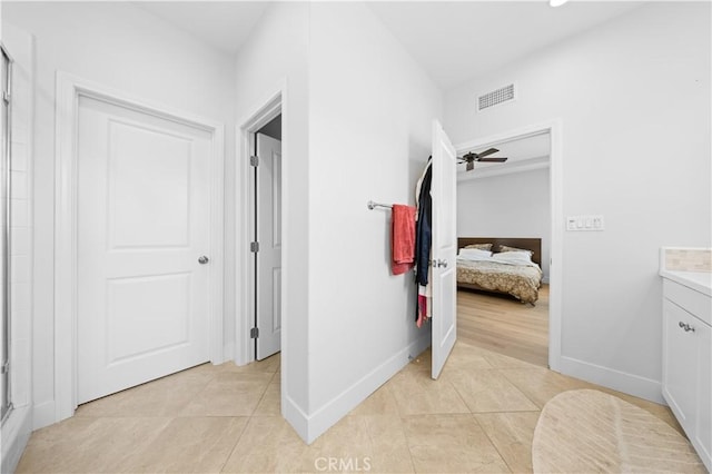 63 Birmingham, Irvine, CA 92620 - ensuite bathroom with tile patterned floors, vanity, baseboards, a shower with shower door, and a ceiling fan