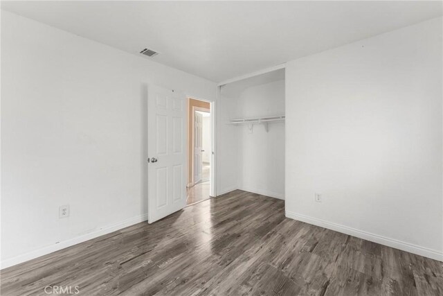 14735 Perham Dr, Moreno Valley, CA 92553 - unfurnished bedroom featuring wood finished floors, baseboards, and a closet