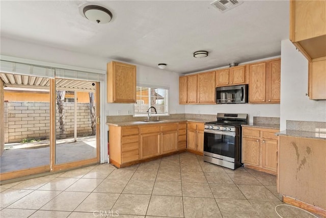 14735 Perham Dr, Moreno Valley, CA 92553 - kitchen featuring appliances with stainless steel finishes, a sink, light countertops, and light tile patterned flooring