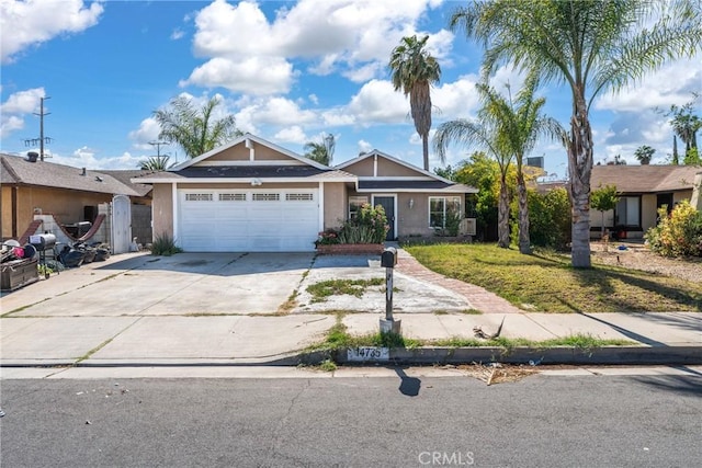 14735 Perham Dr, Moreno Valley, CA 92553 - view of front of house featuring stucco siding, a garage, concrete driveway, and a front lawn