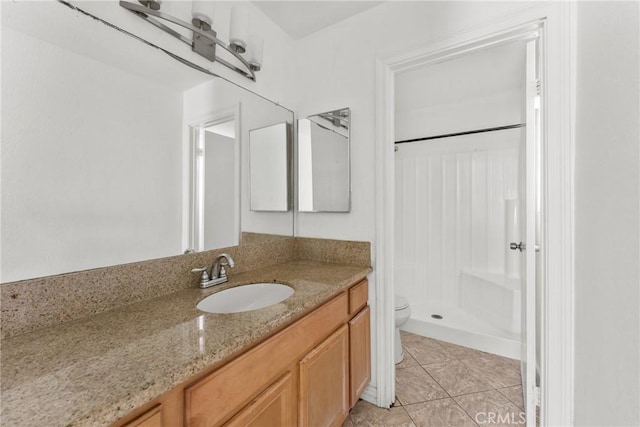 14735 Perham Dr, Moreno Valley, CA 92553 - full bath with a stall shower, toilet, vanity, and tile patterned flooring