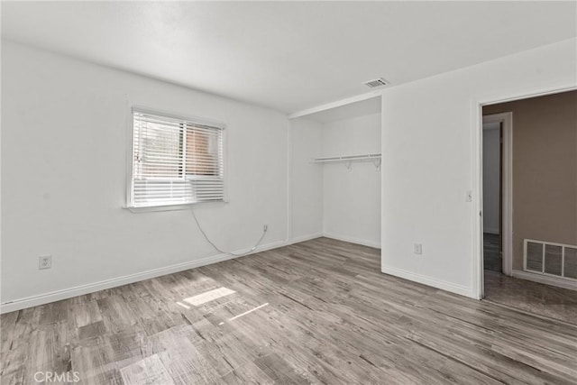14735 Perham Dr, Moreno Valley, CA 92553 - unfurnished bedroom featuring wood finished floors, baseboards, and a closet