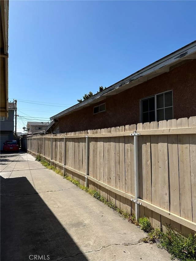 view of side of property with fence