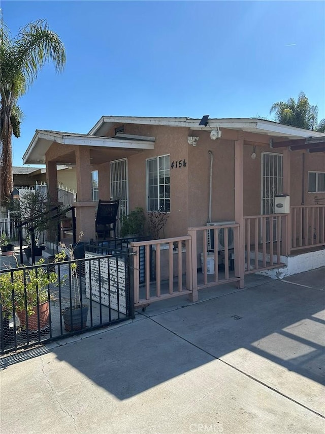 view of front of property with stucco siding and fence