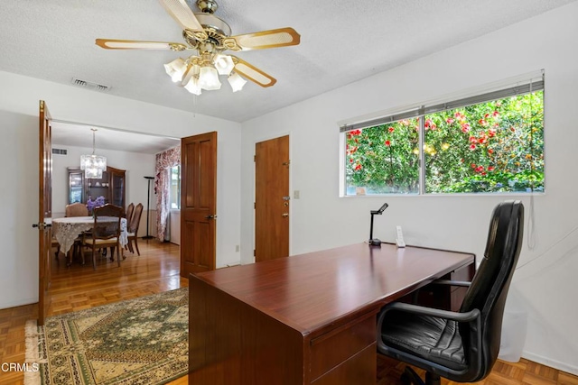 home office featuring visible vents, plenty of natural light, and ceiling fan with notable chandelier