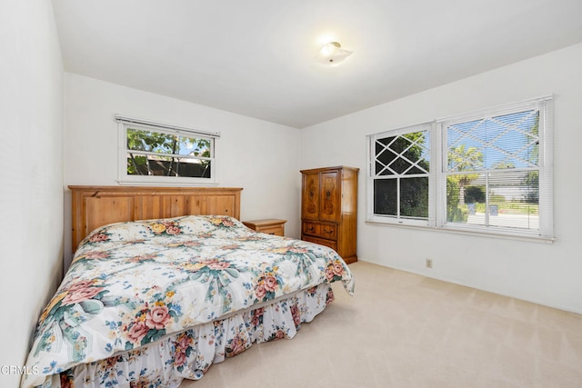 carpeted bedroom featuring multiple windows