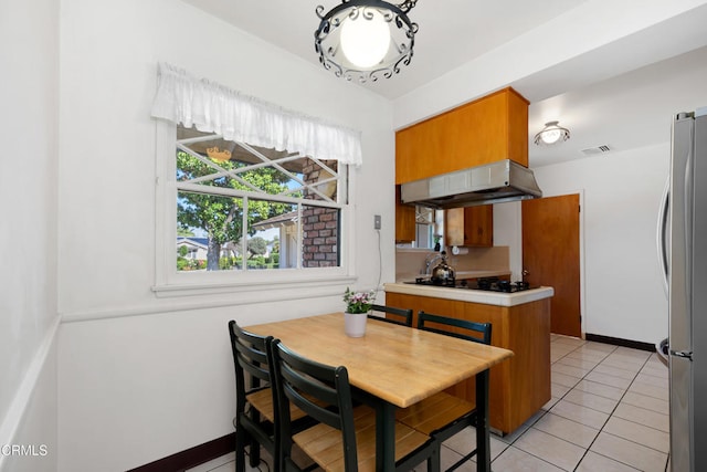 dining room with baseboards and light tile patterned floors