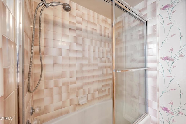 bathroom featuring bath / shower combo with glass door