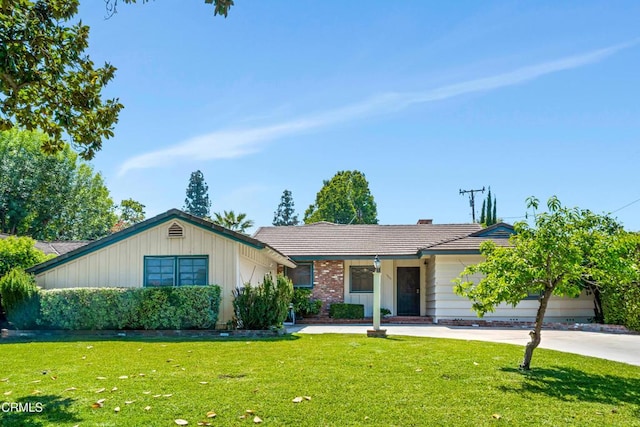 ranch-style home with a front lawn and a tile roof