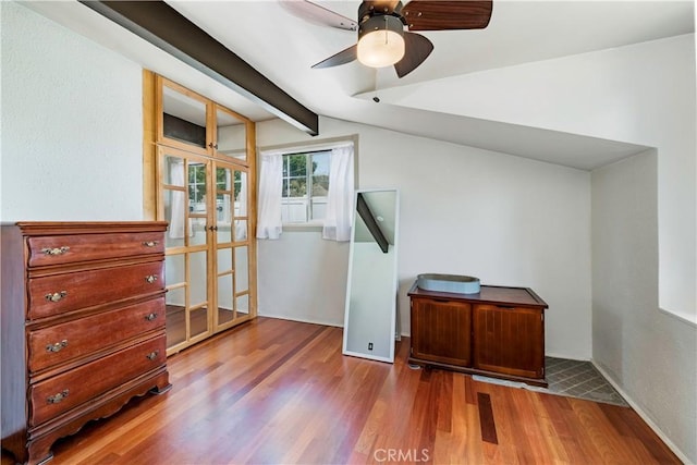 additional living space with a ceiling fan, wood finished floors, and lofted ceiling with beams