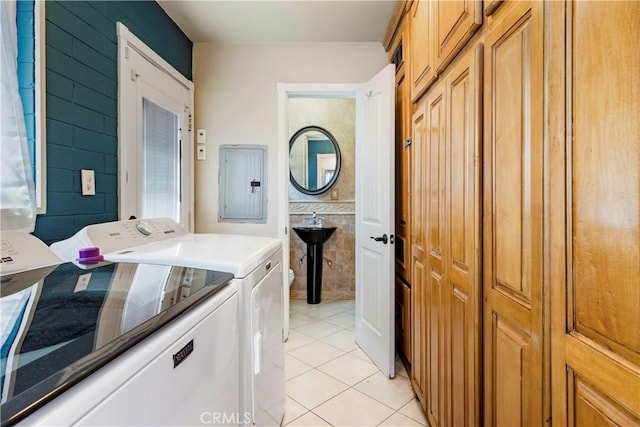 laundry area featuring separate washer and dryer, laundry area, light tile patterned floors, and electric panel