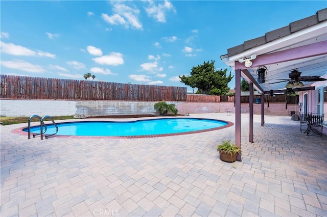 view of swimming pool featuring a patio, a fenced in pool, and a fenced backyard