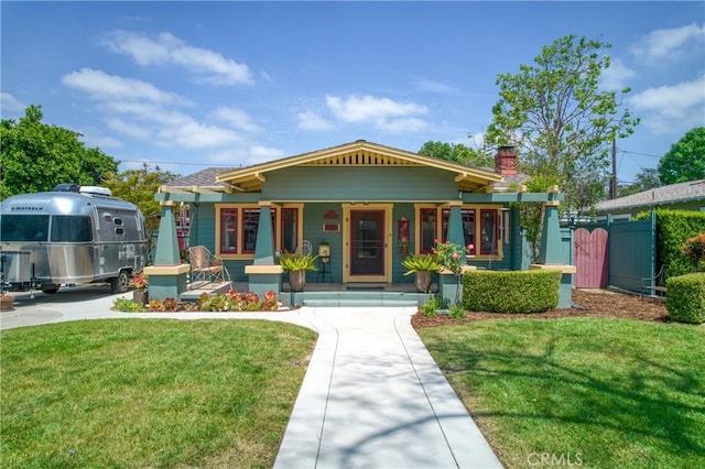 221 Jacaranda Pl, Fullerton, CA 92832 - view of front of house with covered porch, fence, a chimney, and a front yard
