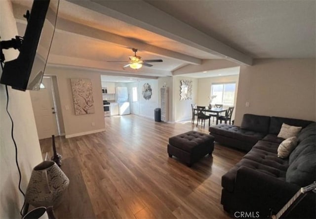 living room with wood finished floors, baseboards, ceiling fan, and vaulted ceiling with beams