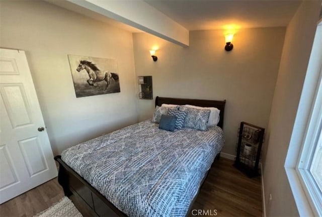 bedroom with baseboards and wood finished floors