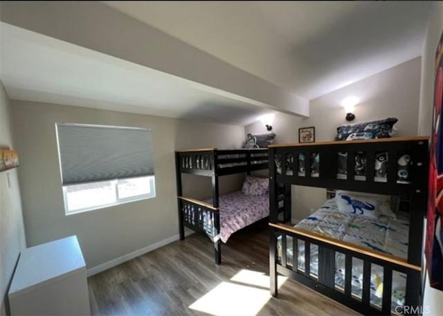 bedroom featuring wood finished floors and baseboards