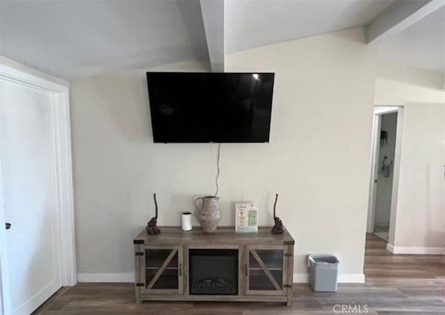 interior details with wood finished floors, baseboards, and beamed ceiling
