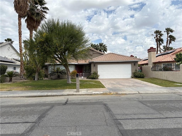 68430 Concepcion Rd, Cathedral City, CA 92234 - ranch-style home with an attached garage, a tiled roof, fence, a front yard, and driveway