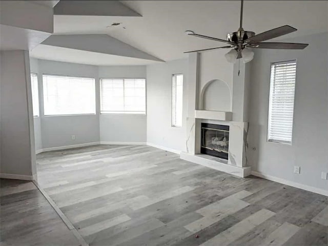 68430 Concepcion Rd, Cathedral City, CA 92234 - unfurnished living room featuring vaulted ceiling, a high end fireplace, a ceiling fan, and a healthy amount of sunlight