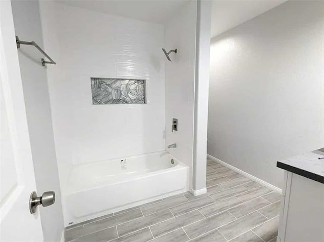 68430 Concepcion Rd, Cathedral City, CA 92234 - full bathroom with baseboards, wood finish floors, vanity, and shower / bathing tub combination