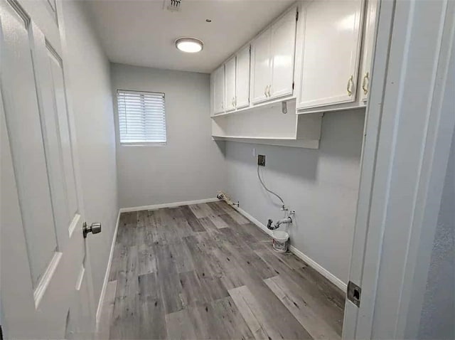 68430 Concepcion Rd, Cathedral City, CA 92234 - laundry room featuring baseboards, gas dryer hookup, light wood-type flooring, and cabinet space