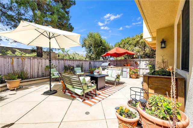 view of patio / terrace with area for grilling, outdoor dining space, a fenced backyard, and grilling area