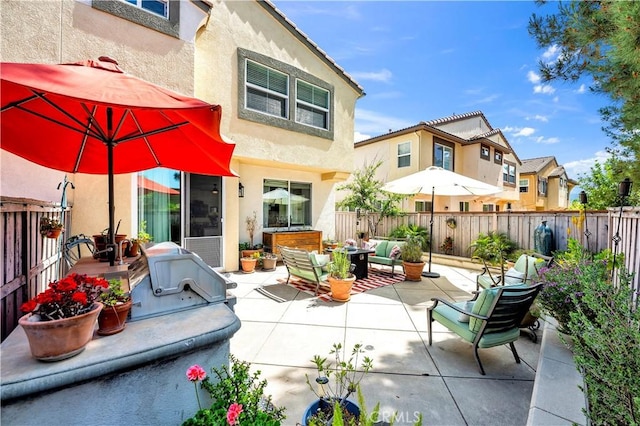 back of house with a fenced backyard, a patio area, and stucco siding