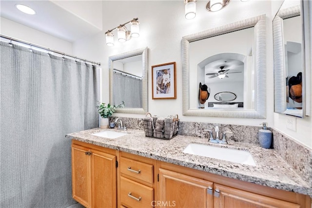 bathroom with a sink, double vanity, and a ceiling fan