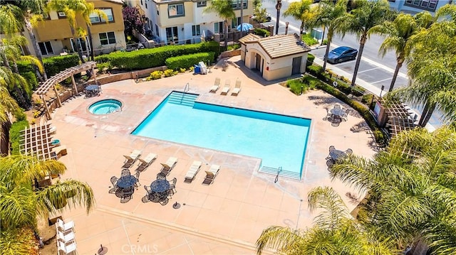 pool featuring a patio area and a community hot tub