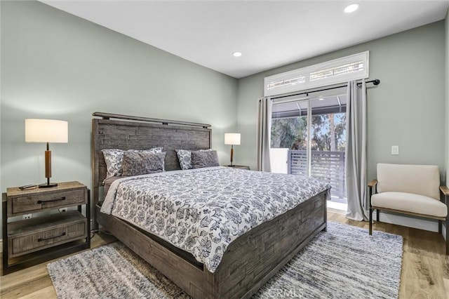 bedroom with light wood-style floors, recessed lighting, and access to exterior