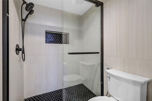 28215 Via Luis, Laguna Niguel, CA 92677 - bathroom with toilet, tile walls, and a stall shower