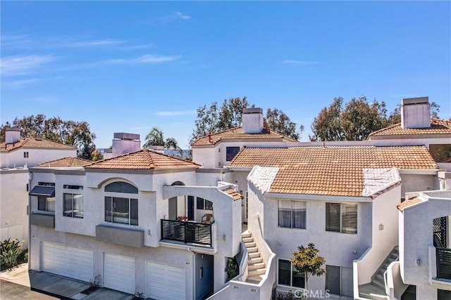 28215 Via Luis, Laguna Niguel, CA 92677 - view of front facade featuring an attached garage, stucco siding, stairs, and a tile roof