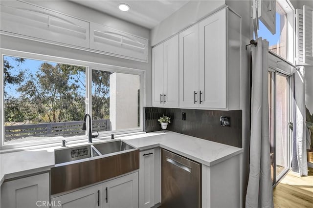 28215 Via Luis, Laguna Niguel, CA 92677 - kitchen with a sink, stainless steel dishwasher, light stone counters, white cabinets, and recessed lighting