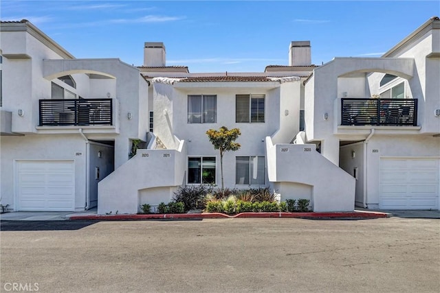 28215 Via Luis, Laguna Niguel, CA 92677 - view of front of house featuring a chimney, a balcony, and stucco siding