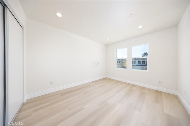737 Lewis St, Pomona, CA 91768 - unfurnished bedroom with a closet, light wood-style flooring, baseboards, and recessed lighting