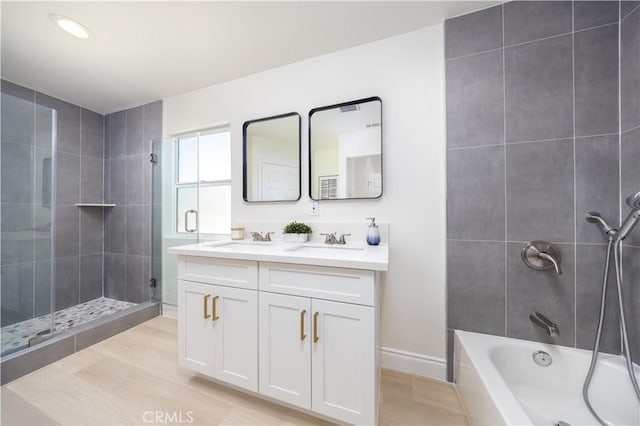 737 Lewis St, Pomona, CA 91768 - full bath with a sink, double vanity, recessed lighting, and wood finished floors