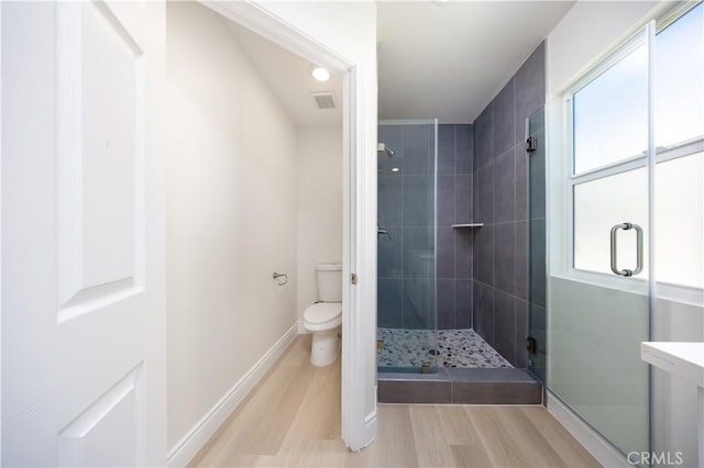 737 Lewis St, Pomona, CA 91768 - full bath with toilet, a wealth of natural light, a shower stall, and wood finished floors