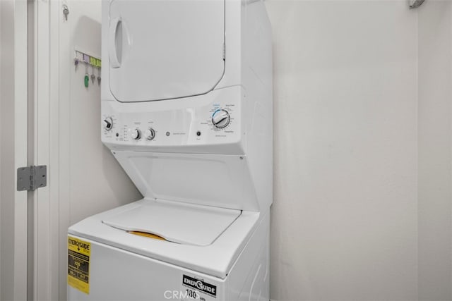 clothes washing area featuring laundry area and stacked washer and dryer