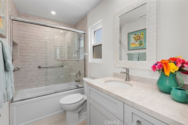 full bathroom featuring vanity, toilet, visible vents, and enclosed tub / shower combo