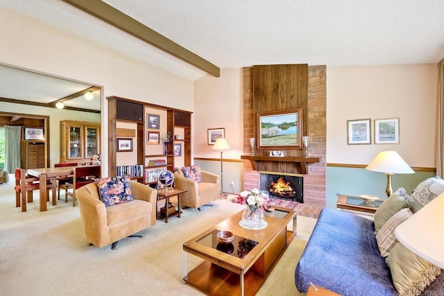 living room with a textured ceiling, vaulted ceiling with beams, a fireplace, and carpet